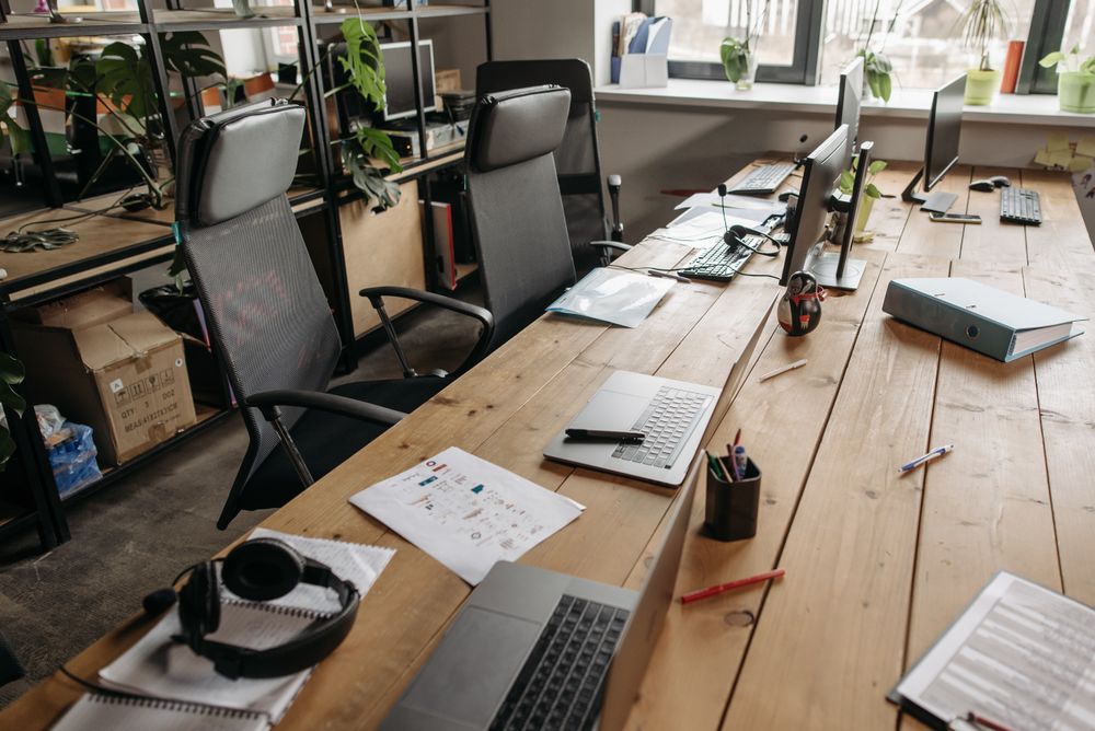 The clean original version of the shared wooden desk workspace