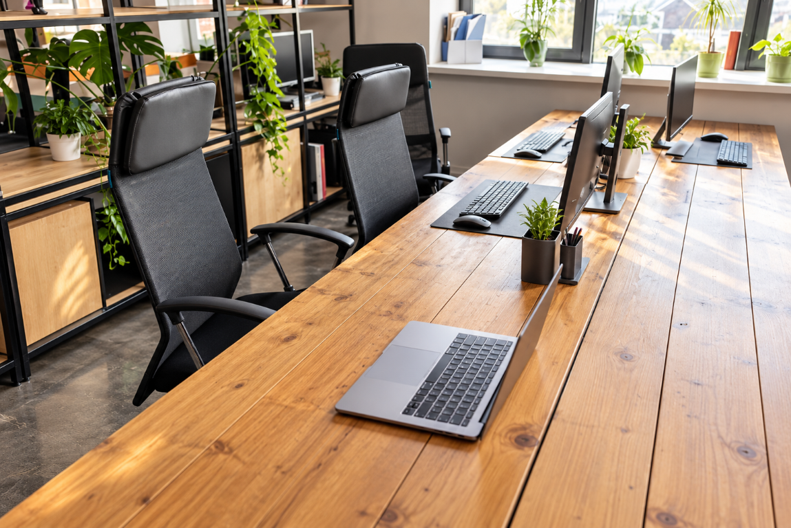 A shared office workspace with scattered papers and equipment before cleaning